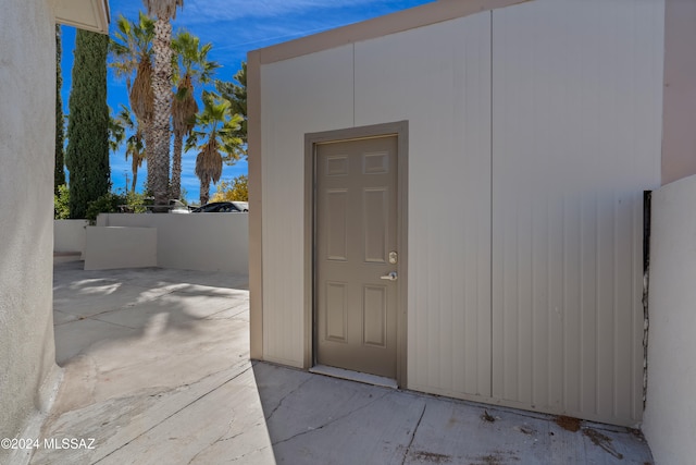 view of exterior entry featuring a patio