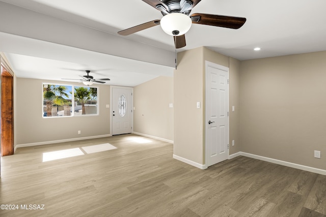 unfurnished living room featuring ceiling fan and light hardwood / wood-style flooring