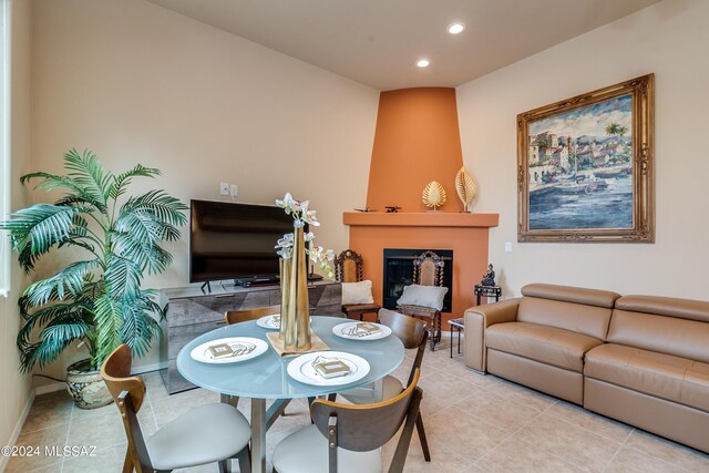 dining room with baseboards, a fireplace, recessed lighting, and light tile patterned flooring