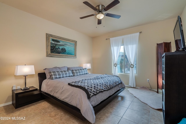 bedroom featuring light tile patterned flooring, baseboards, and ceiling fan