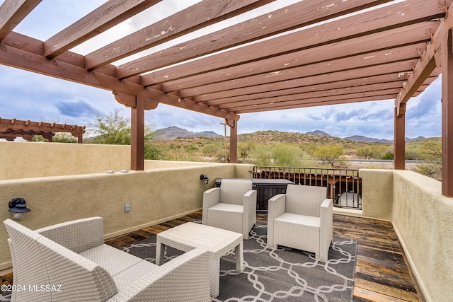 wooden deck featuring a balcony, a pergola, and a mountain view