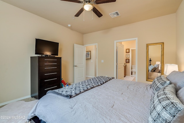 bedroom featuring ensuite bathroom, ceiling fan, and light colored carpet