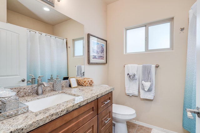 bathroom with vanity, toilet, and tile patterned floors