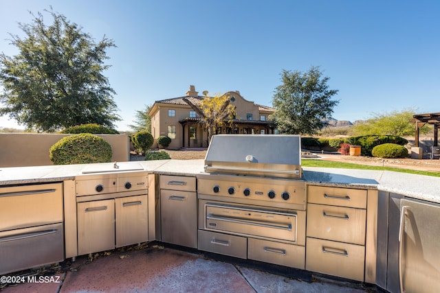 view of patio with an outdoor kitchen and area for grilling