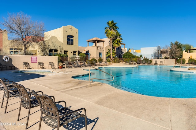 pool featuring fence and a patio area