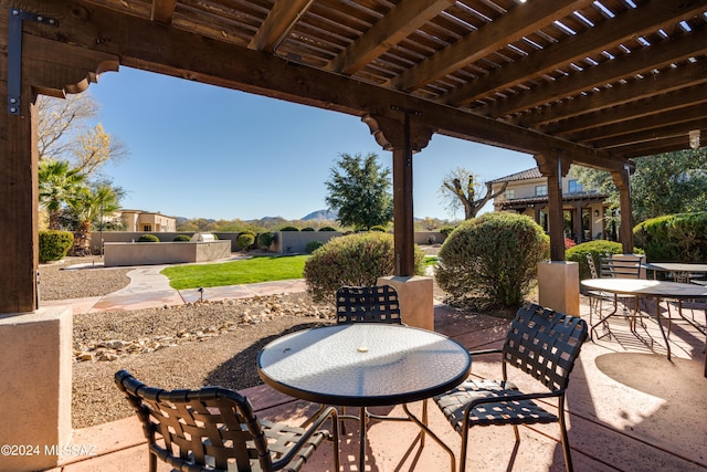 view of patio featuring a pergola and outdoor dining area