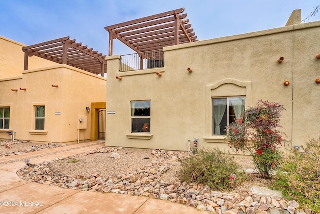 rear view of house with a pergola