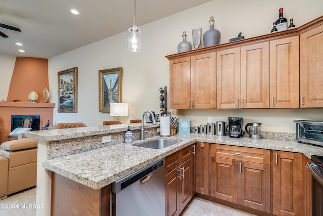 kitchen featuring kitchen peninsula, decorative light fixtures, sink, stainless steel dishwasher, and light stone counters