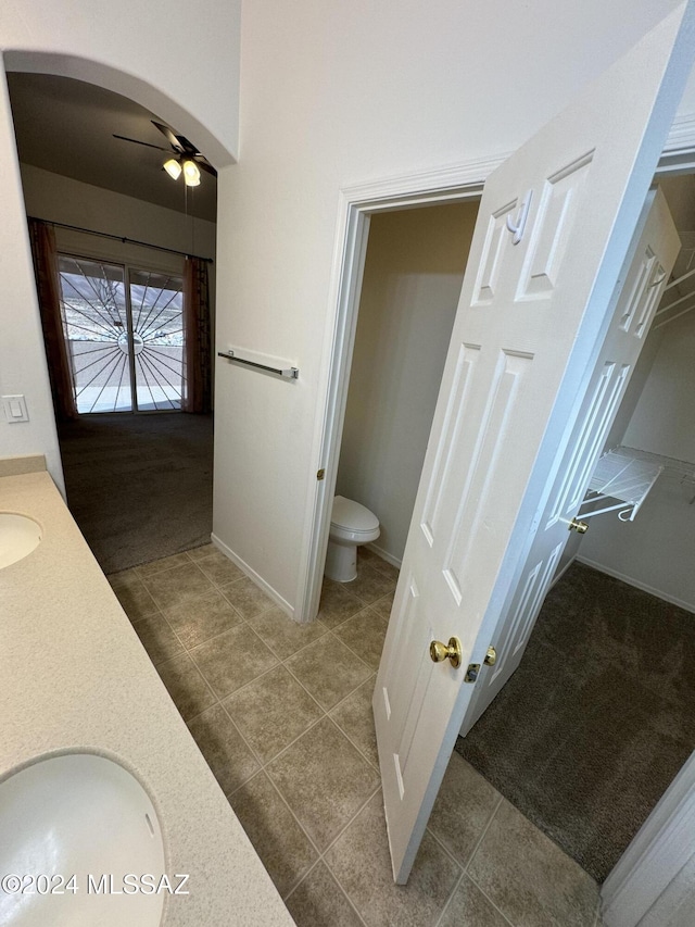 bathroom featuring toilet, ceiling fan, tile patterned flooring, and vanity