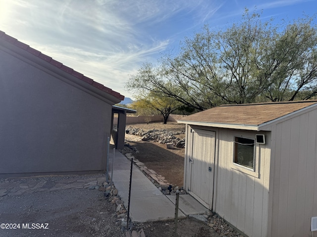 view of property exterior featuring a storage unit