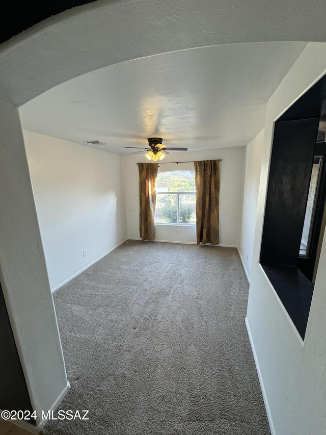 carpeted empty room with ceiling fan