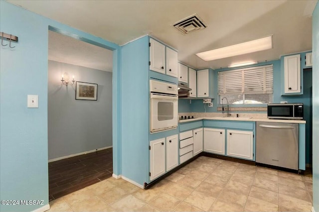 kitchen featuring white cabinetry, sink, and appliances with stainless steel finishes