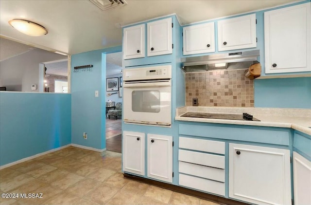 kitchen with white cabinets, decorative backsplash, white oven, and black electric cooktop