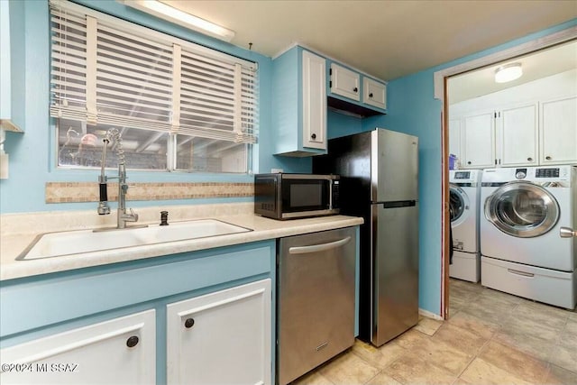 kitchen featuring white cabinetry, sink, blue cabinets, washer and dryer, and appliances with stainless steel finishes