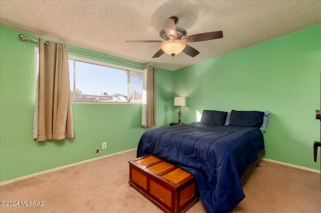 carpeted bedroom with a textured ceiling and ceiling fan