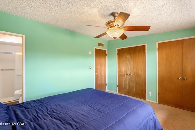 1580 E Andrea Dr, Sierra Vista, AZ 85635 - bedroom featuring visible vents, a ceiling fan, carpet floors, two closets, and a textured ceiling