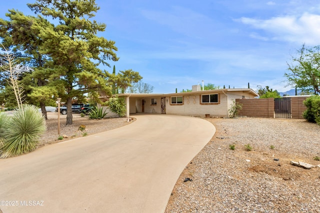 1580 E Andrea Dr, Sierra Vista, AZ 85635 - ranch-style house featuring a gate, a chimney, fence, brick siding, and curved driveway