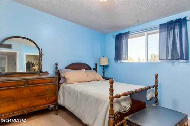 carpeted bedroom featuring a textured ceiling