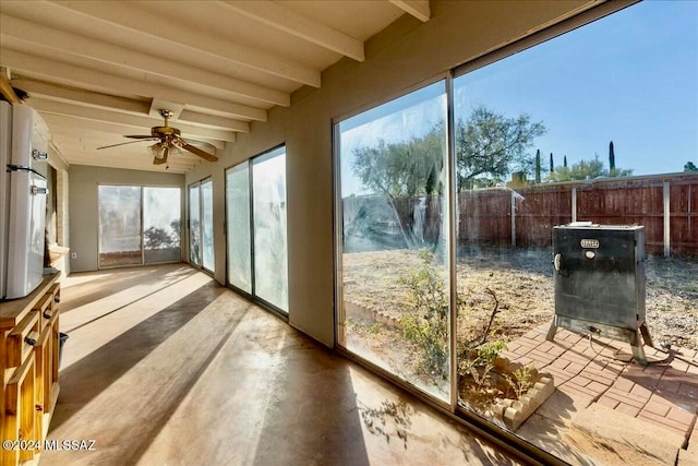 sunroom with beam ceiling and ceiling fan