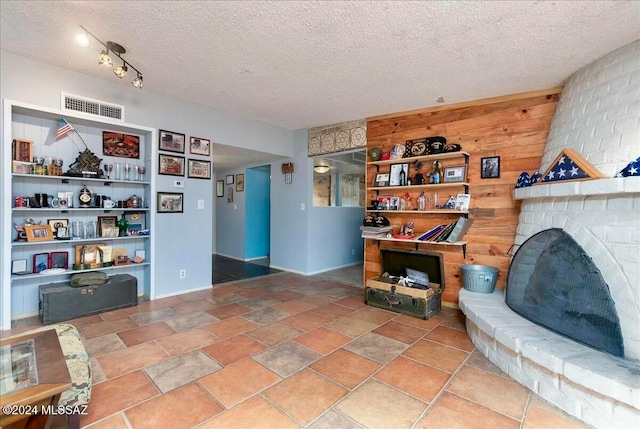 interior space with a fireplace and a textured ceiling