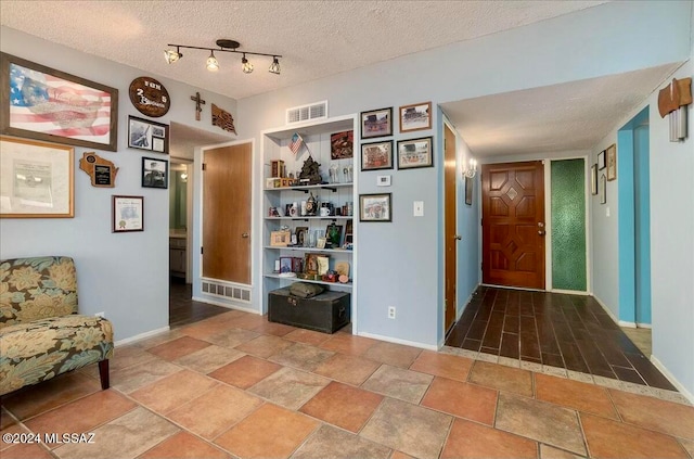 hall with a textured ceiling