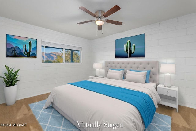 carpeted bedroom with brick wall and ceiling fan