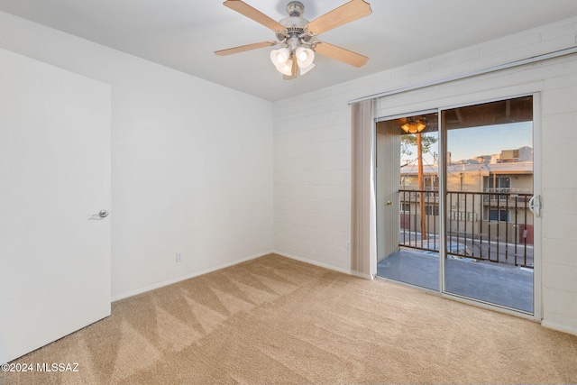 carpeted empty room featuring ceiling fan