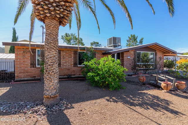 single story home featuring central air condition unit