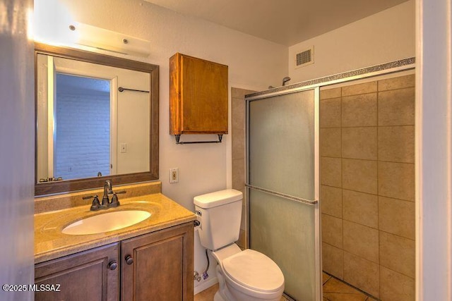 bathroom featuring vanity, toilet, an enclosed shower, and tile patterned flooring