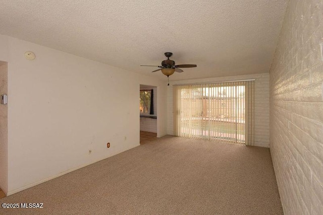 unfurnished room with ceiling fan, carpet floors, and a textured ceiling