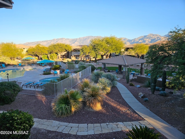 view of home's community featuring a mountain view, a gazebo, a pool, and a patio area