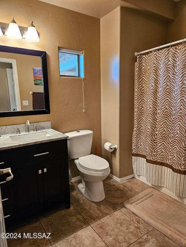 bathroom with tile patterned flooring, a shower with curtain, vanity, and toilet