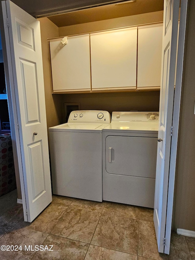 washroom featuring cabinets and washer and dryer
