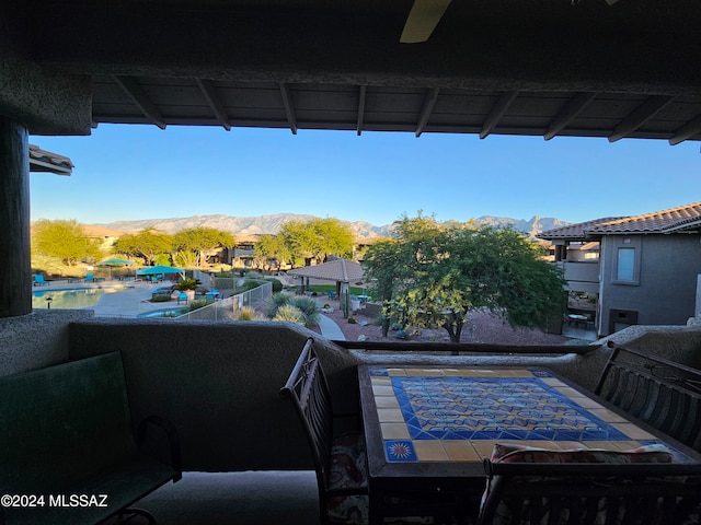view of patio / terrace with a mountain view and ceiling fan
