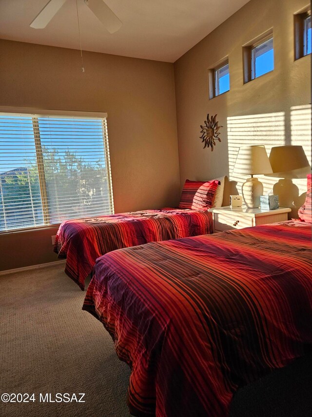 bedroom with carpet flooring, multiple windows, and ceiling fan