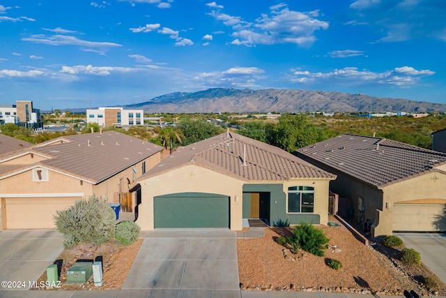 view of front of home featuring a mountain view and a garage