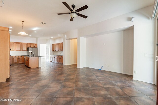 tiled spare room featuring ceiling fan and french doors