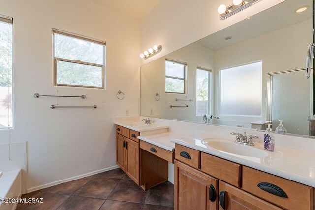 bathroom with tile patterned flooring, vanity, and a shower with shower door