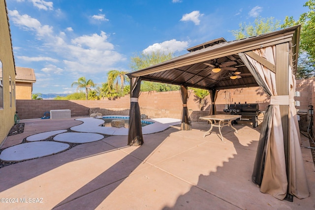 view of patio / terrace with a gazebo, a grill, ceiling fan, and a pool