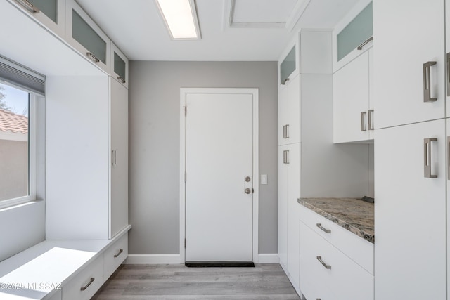 mudroom featuring baseboards and light wood-type flooring
