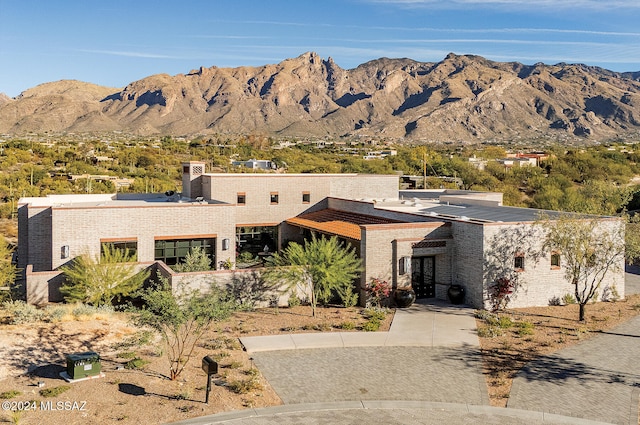 view of front facade featuring a mountain view and brick siding