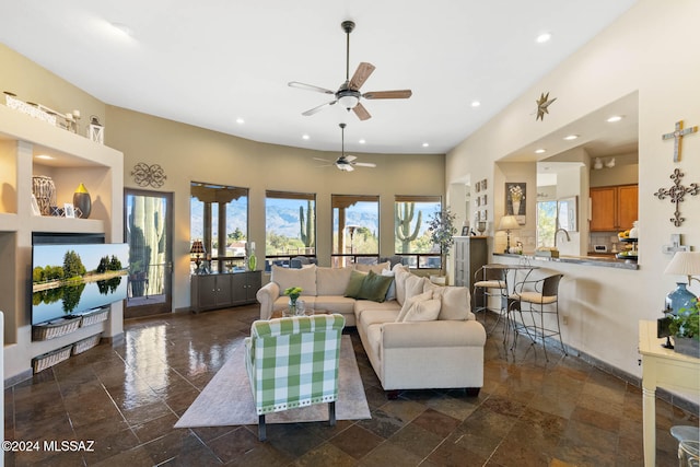 living room featuring ceiling fan and sink