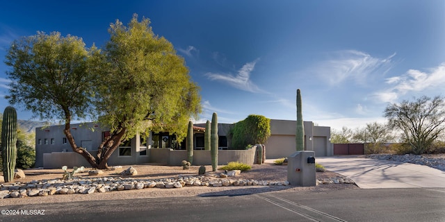 pueblo-style home featuring a garage