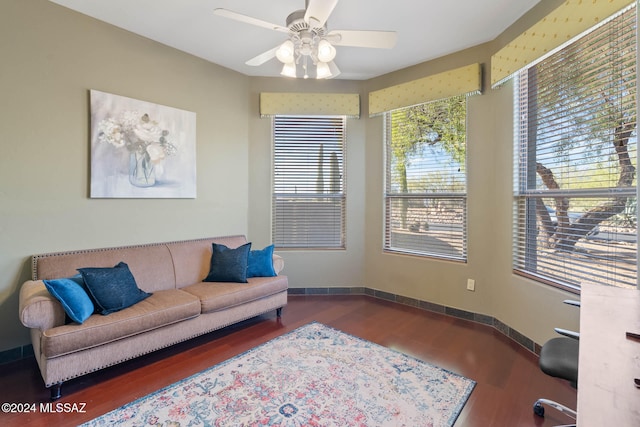 living room featuring hardwood / wood-style floors and ceiling fan