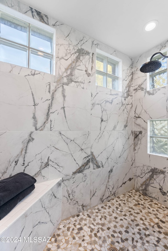 bathroom with tiled shower