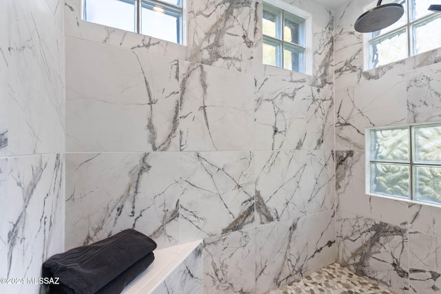 bathroom featuring a tile shower