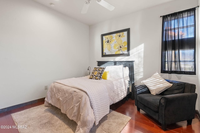 bedroom with ceiling fan and dark wood-type flooring