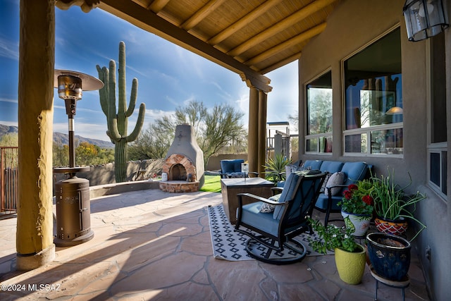 view of patio / terrace with an outdoor stone fireplace