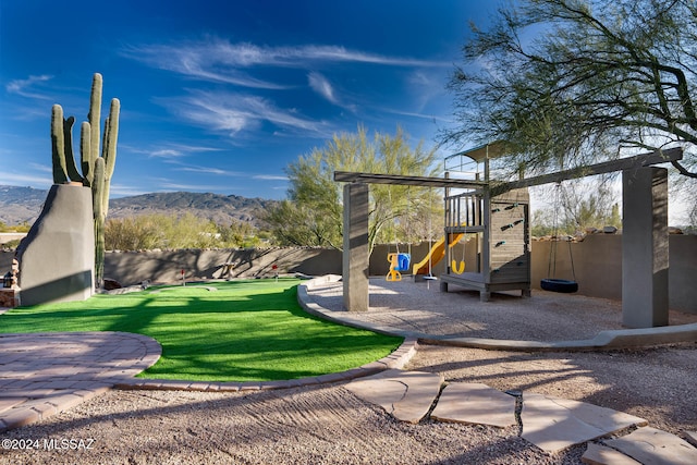 view of jungle gym featuring a mountain view