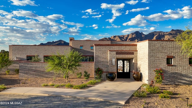 view of front facade with a mountain view and french doors